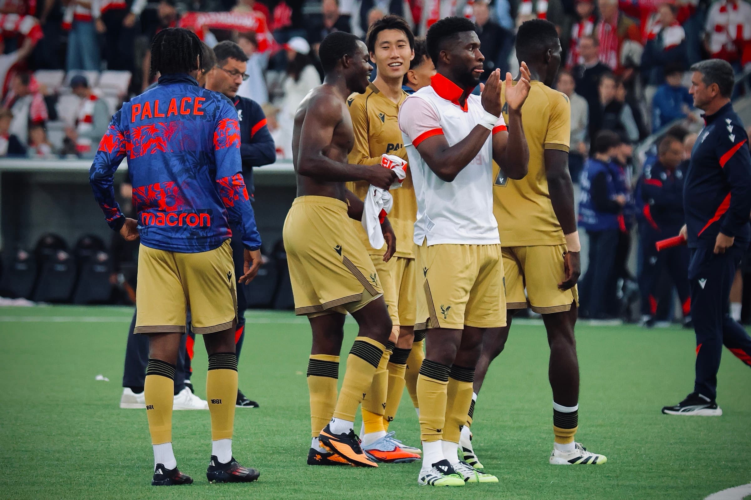 Crystal Palace players applauding fans on the pitch after a match against Fredrikstad